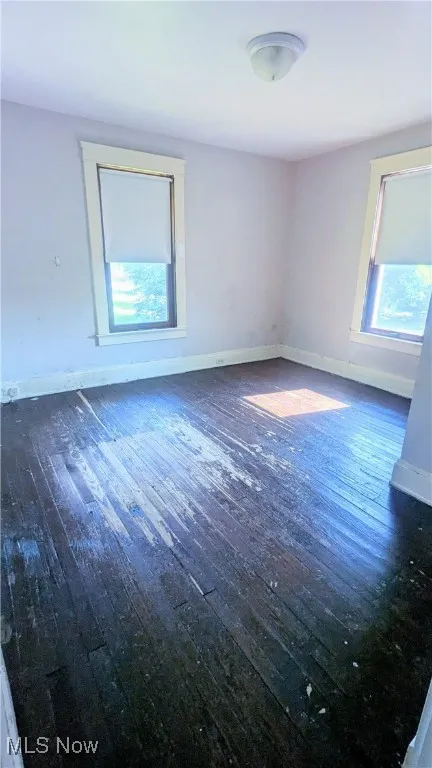 View of primary bedroom with hardwood floors