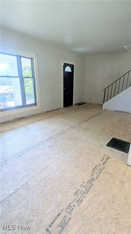 view of spacious living room and front entry