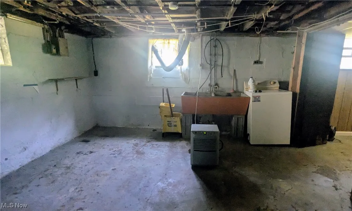 view of laundry area in basement washer stays