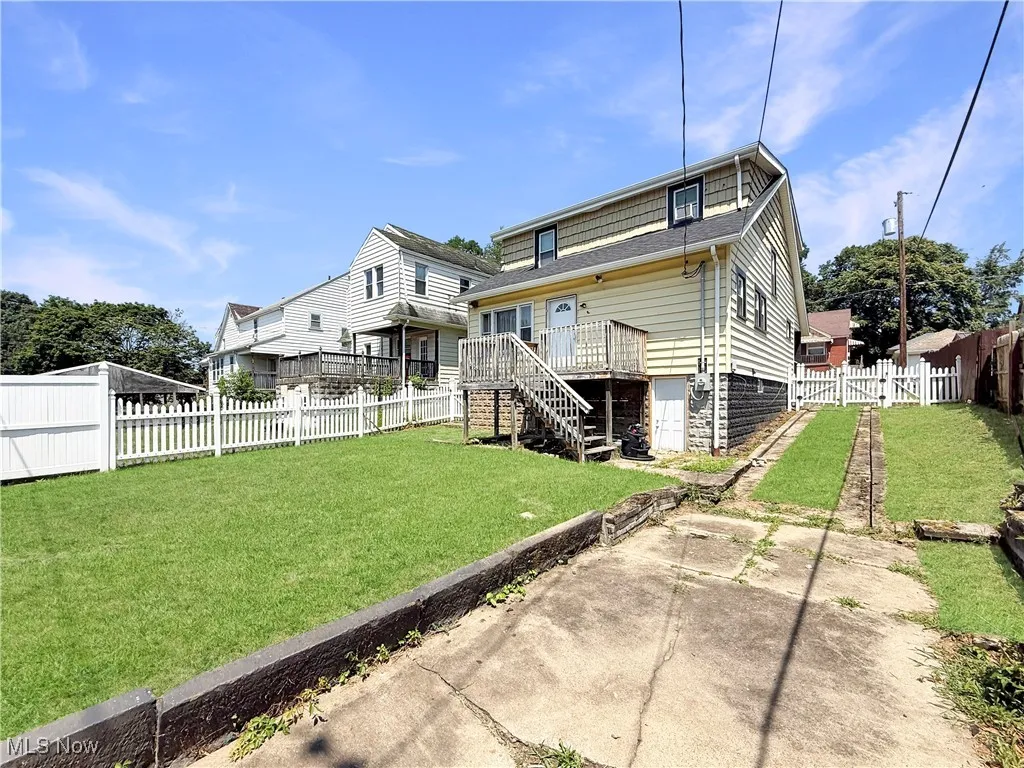 Back of house featuring stairway, a fenced backyard, and a patio area