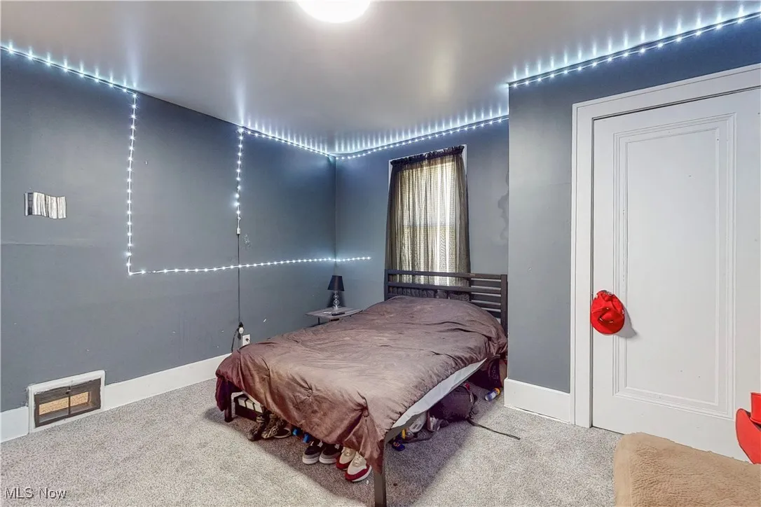 Bedroom featuring carpet floors and baseboards