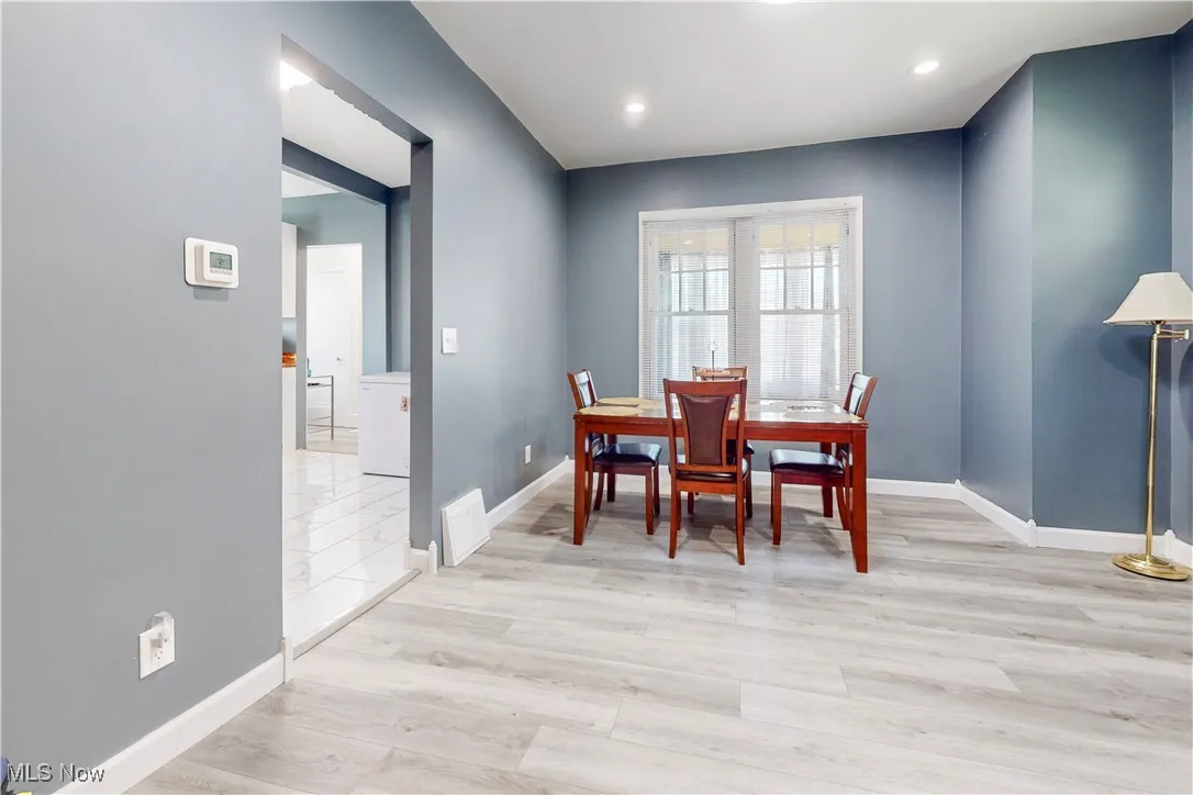 Dining space with light wood-type flooring and recessed lighting