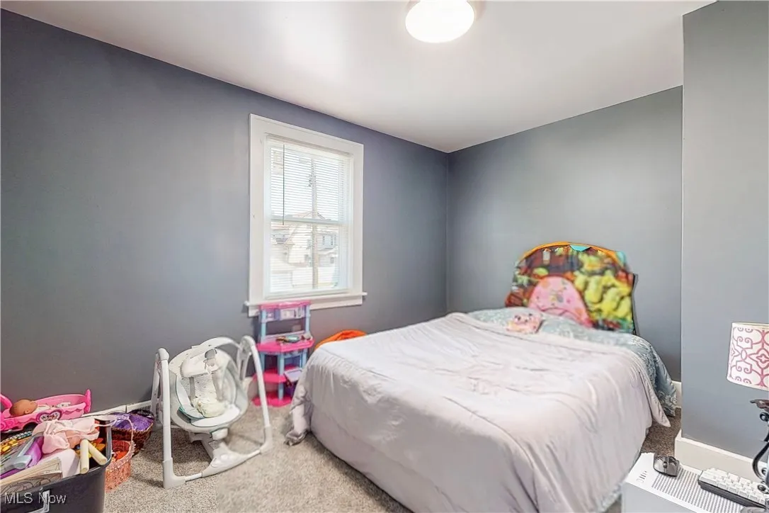 Carpeted bedroom with baseboards