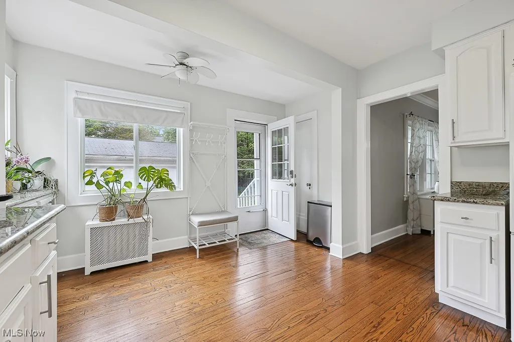 Entryway with light wood-type flooring, ceiling fan, and radiator