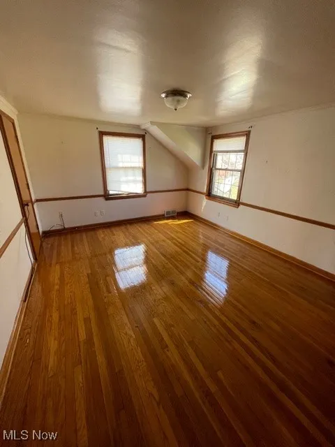 Spare room featuring light wood-style floors and baseboards