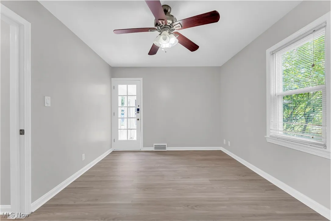 Spare room with light wood finished floors and ceiling fan