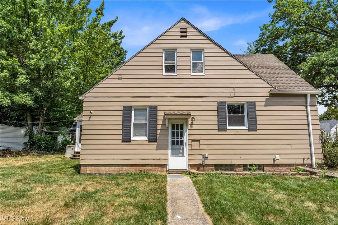 View of front of home featuring a front yard and roof with shingles