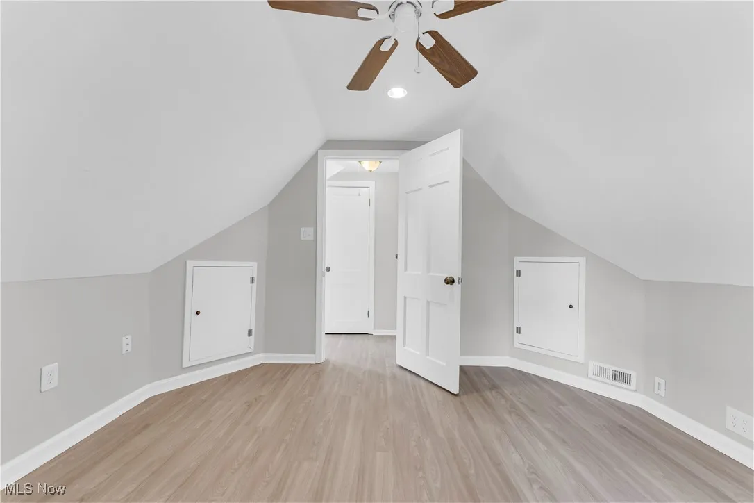 Bonus room featuring light wood-style floors, lofted ceiling, a ceiling fan, and recessed lighting