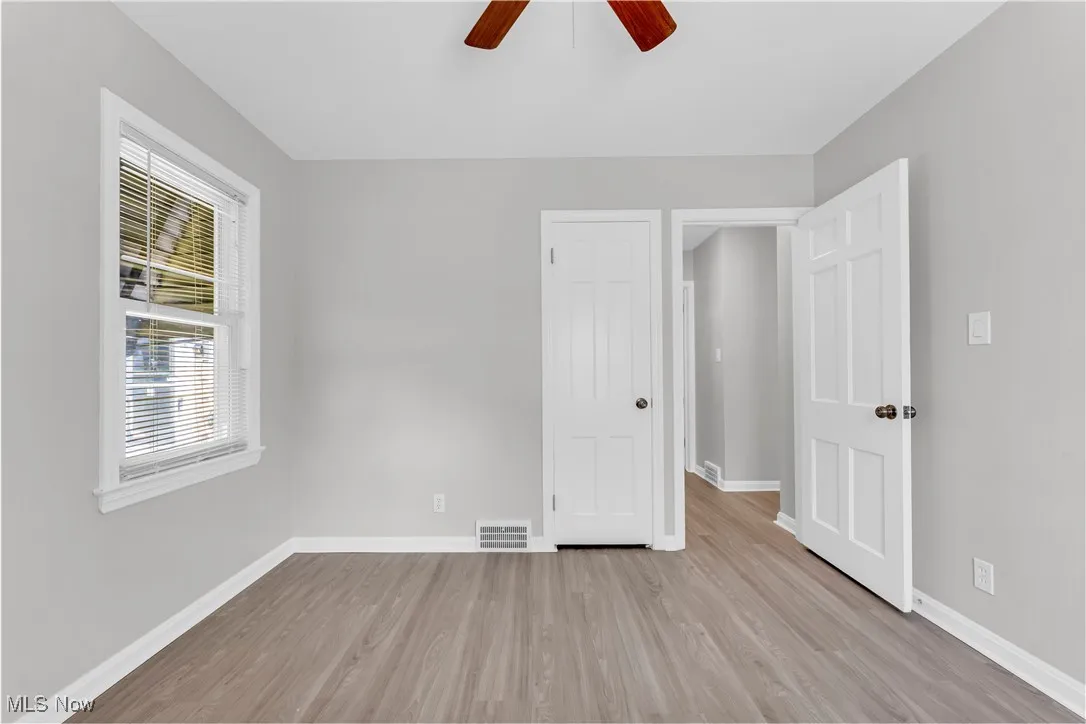 Unfurnished bedroom featuring wood finished floors and a ceiling fan