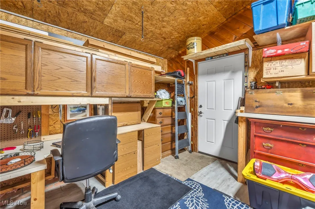 Office area with lofted ceiling and light wood finished floors