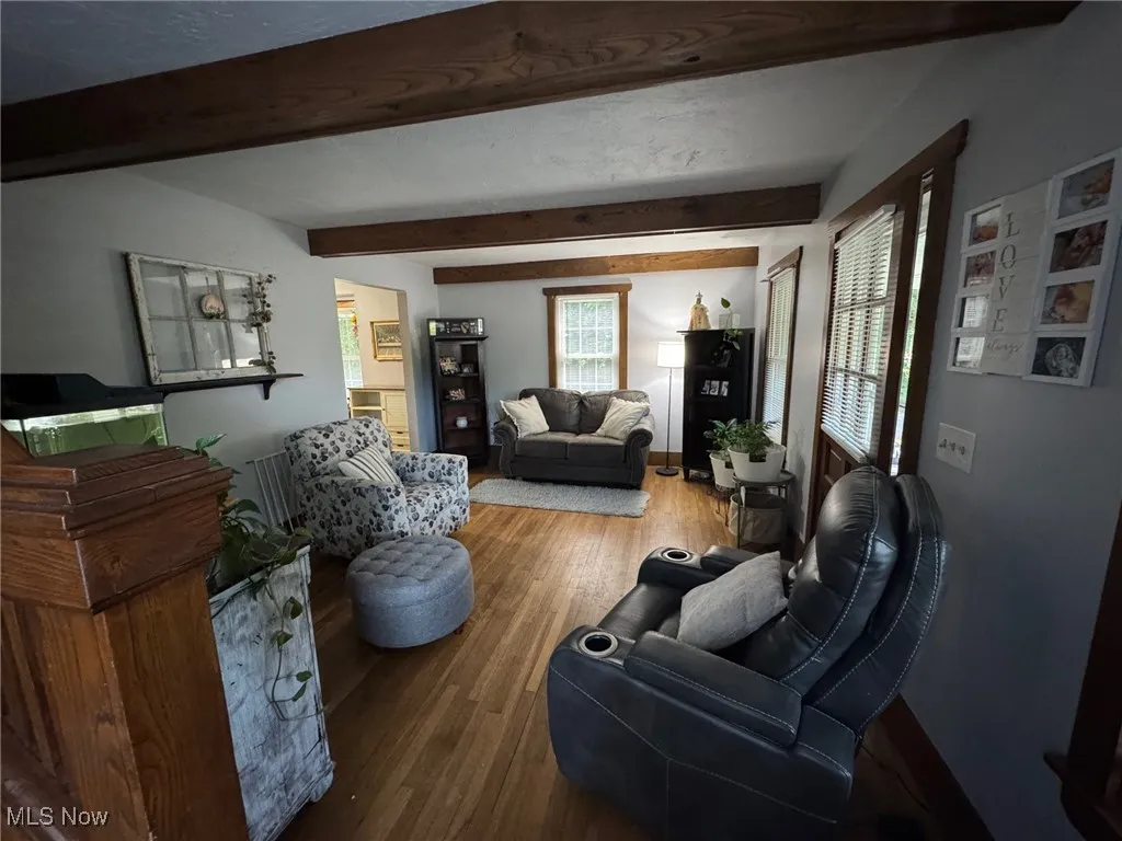 Living area featuring wood finished floors and wood beams and natural woodwork
