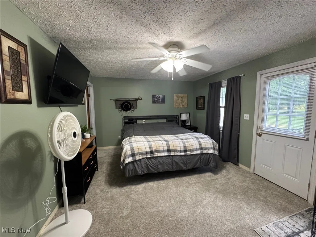 Bedroom with carpet flooring, and ceiling fan