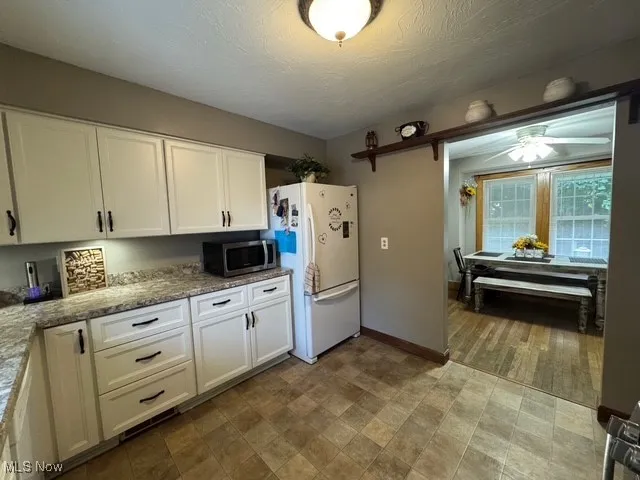 Kitchen view of large drawers for storage and shelving