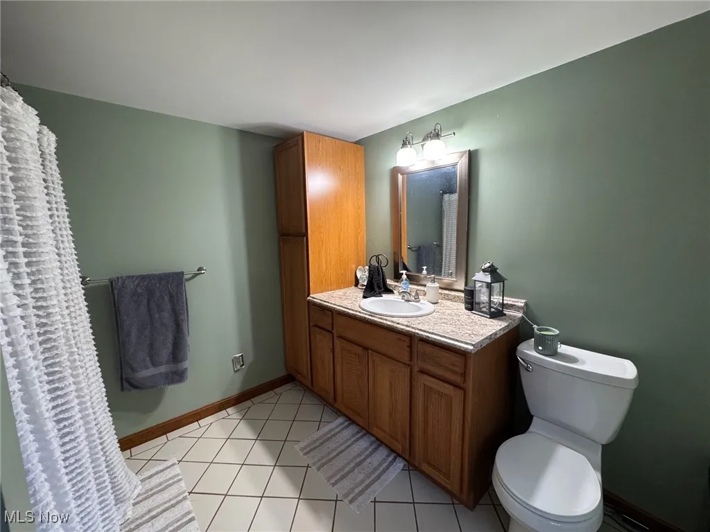 Full bath with vanity and tub shower combo