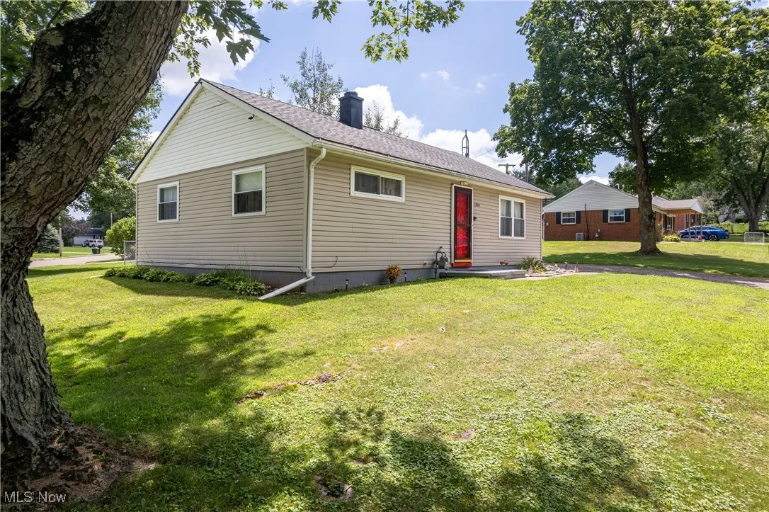 Single story home with a front yard, a chimney, and roof with shingles