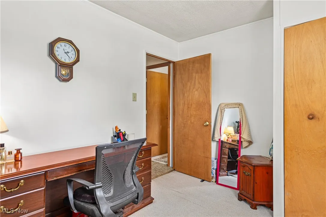 Carpeted bedroom featuring a textured ceiling