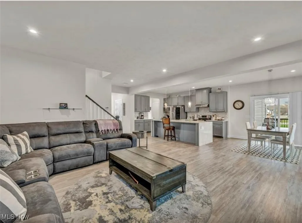 Living room featuring light wood finished floors and recessed lighting