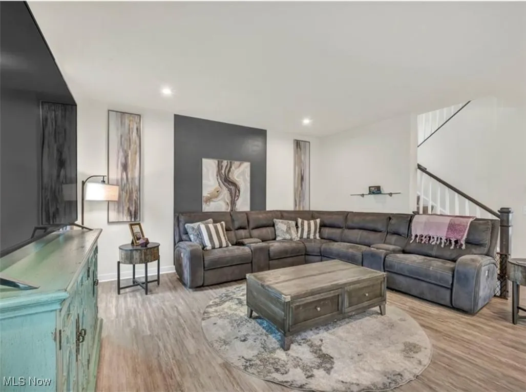 Living area featuring light wood-type flooring and recessed lighting