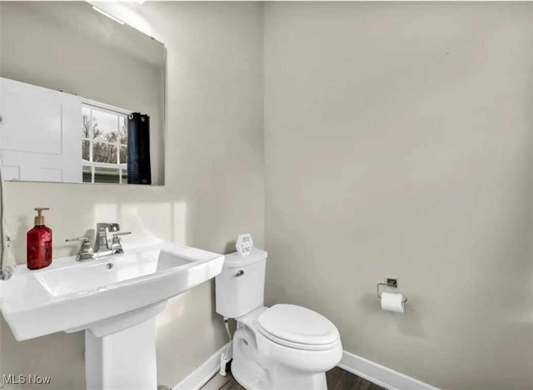 Bathroom featuring baseboards and wood finished floors