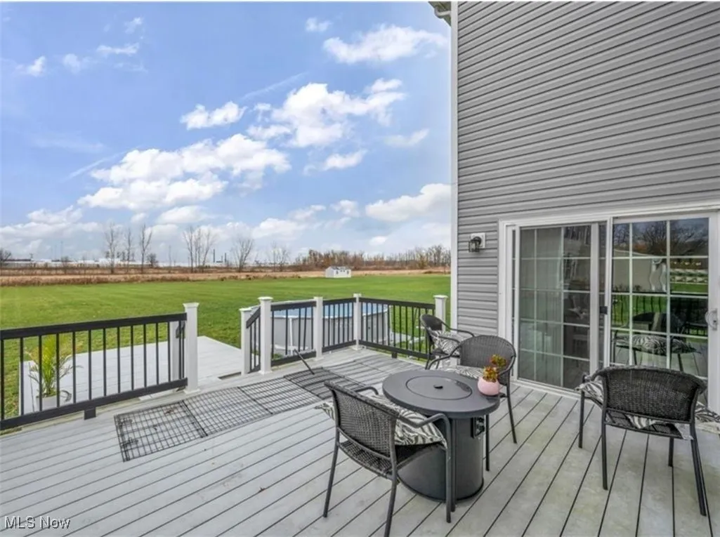 Wooden terrace featuring a yard