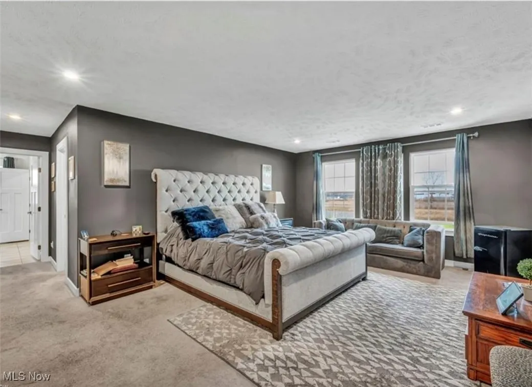 Carpeted bedroom featuring recessed lighting and a textured ceiling