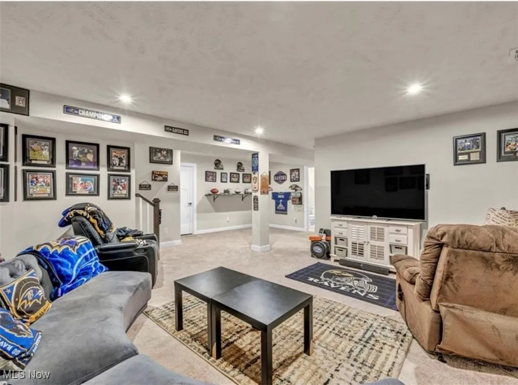 Living room with recessed lighting and light carpet