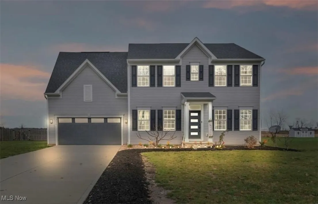 Colonial home with driveway and an attached garage