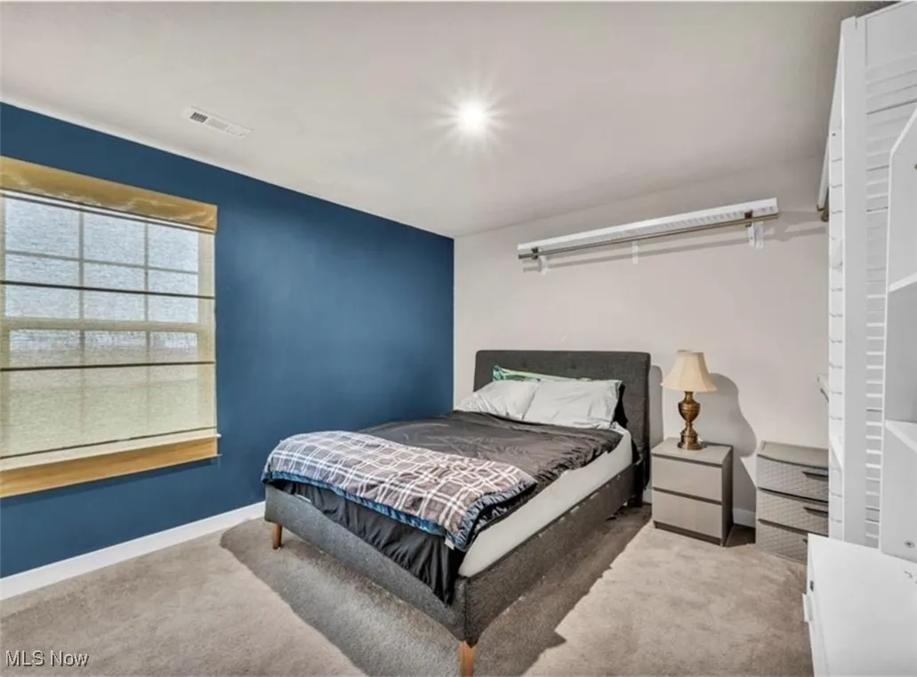 Bedroom featuring carpet flooring and baseboards