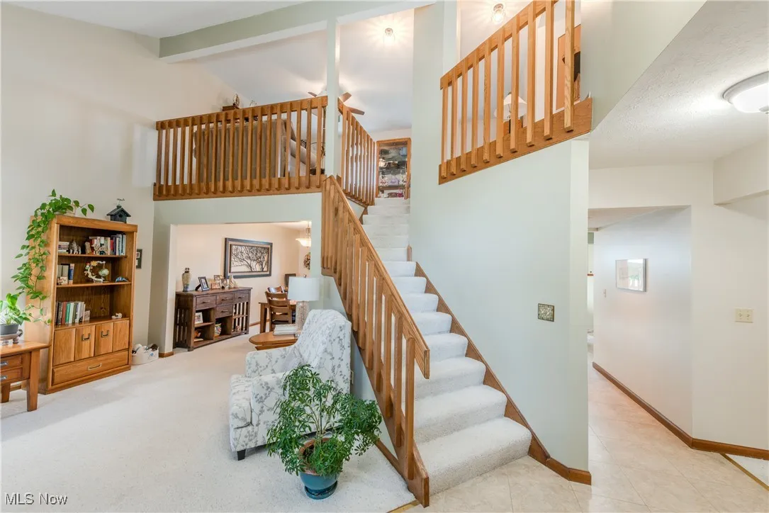Staircase in living room leading to second floor loft