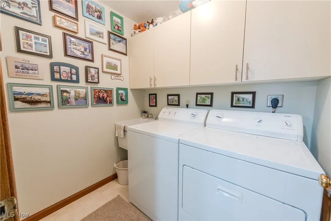 Laundry room with separate washer and dryer, Utility Sink, and cabinet space