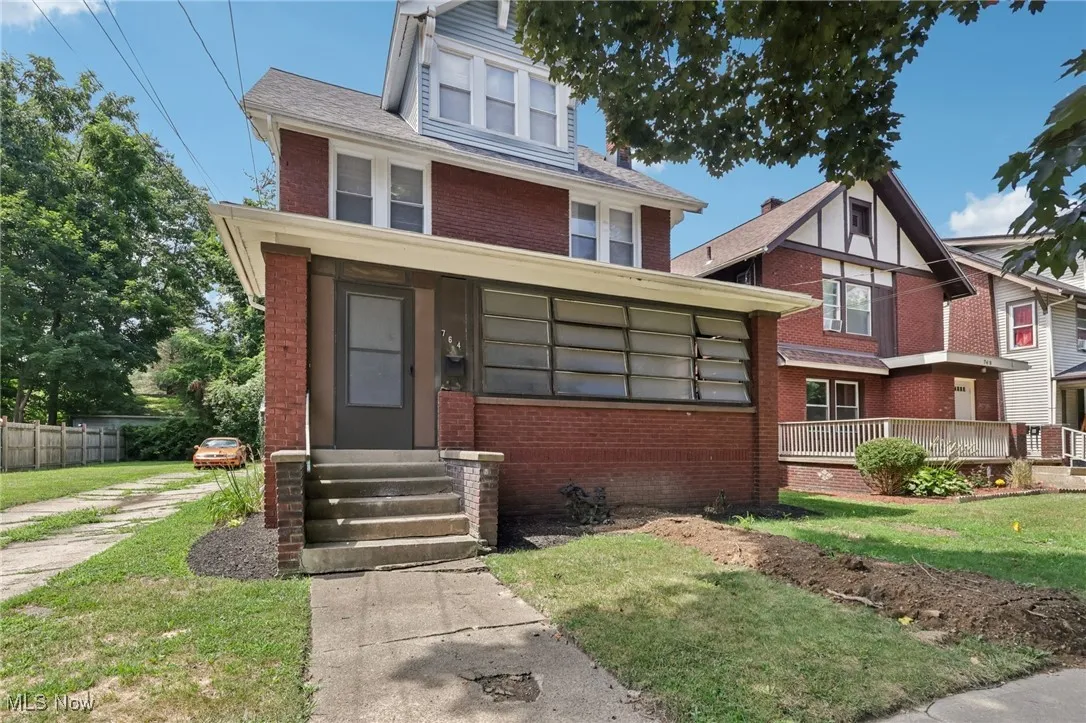 View of front of home with entry steps and brick siding