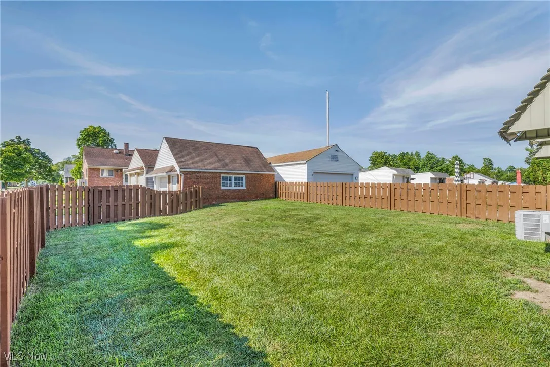 Fenced backyard featuring a residential view