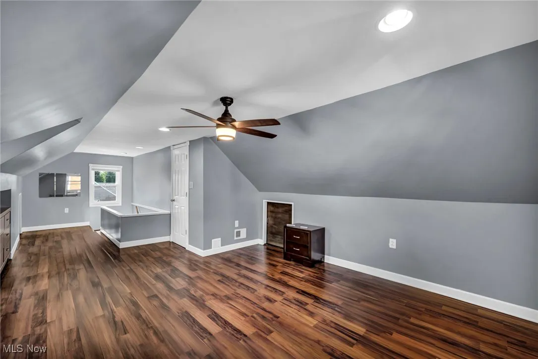 Bonus room featuring dark wood-style floors, lofted ceiling, recessed lighting, and a ceiling fan