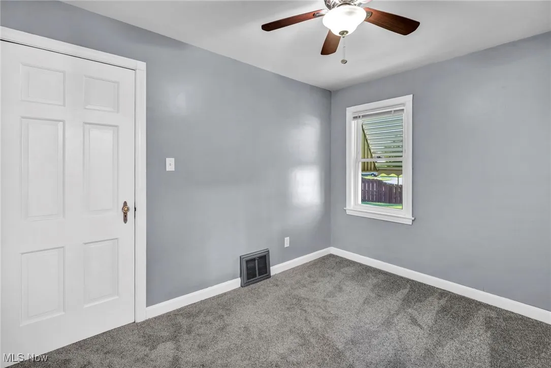 Unfurnished room with carpet floors and ceiling fan