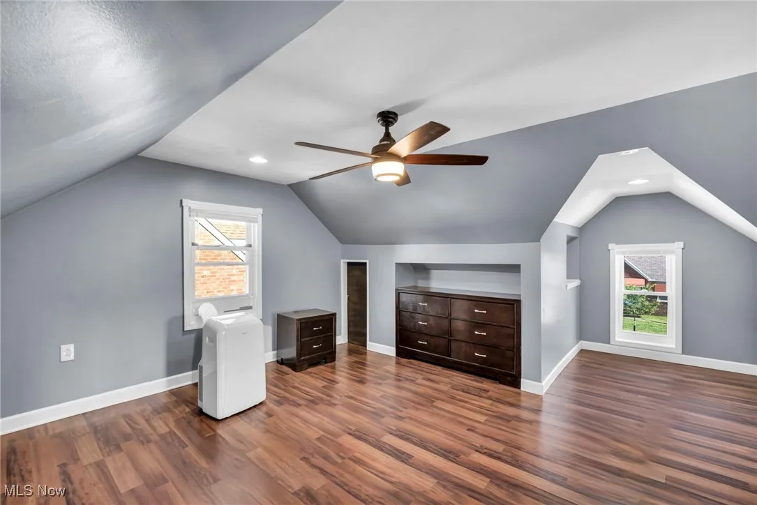 Bonus room featuring dark wood-style floors, recessed lighting, and lofted ceiling
