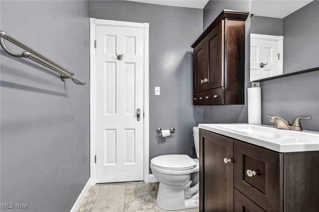 Bathroom featuring vanity and marble finish flooring