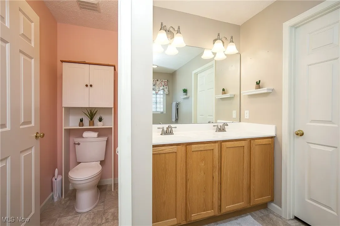Bathroom featuring double vanity and toilet