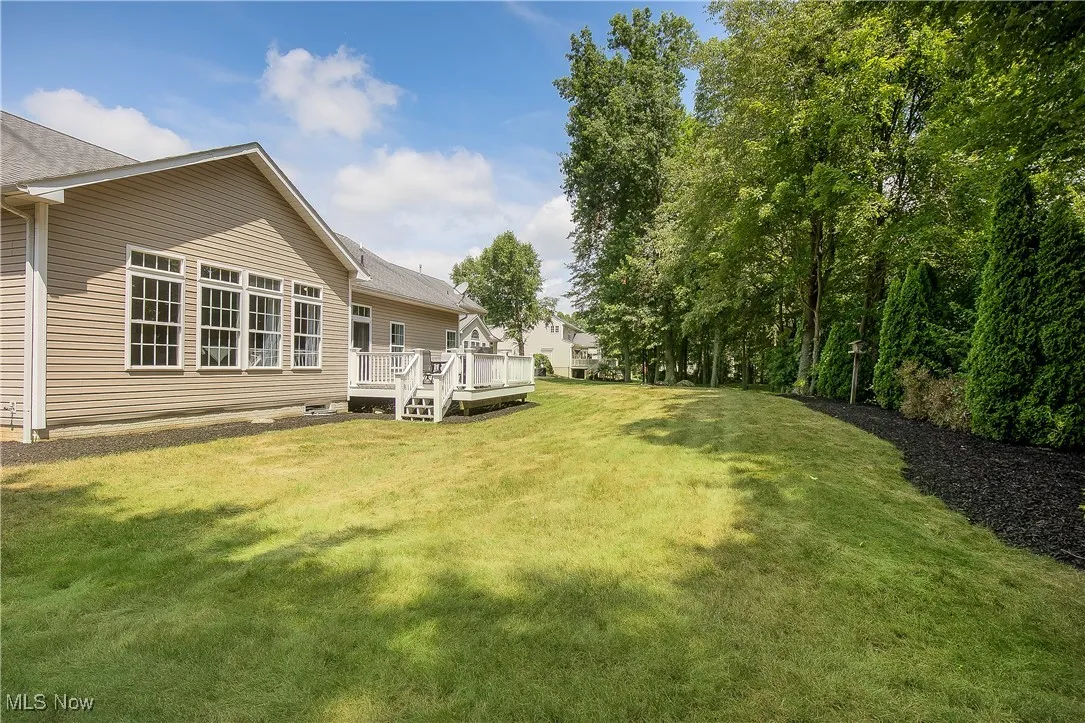 View of green lawn with a deck