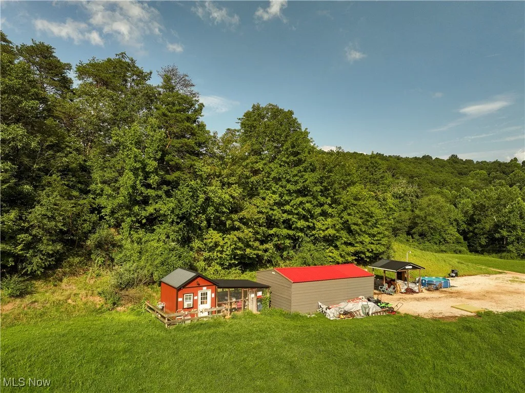 View of subject property with a heavily wooded area