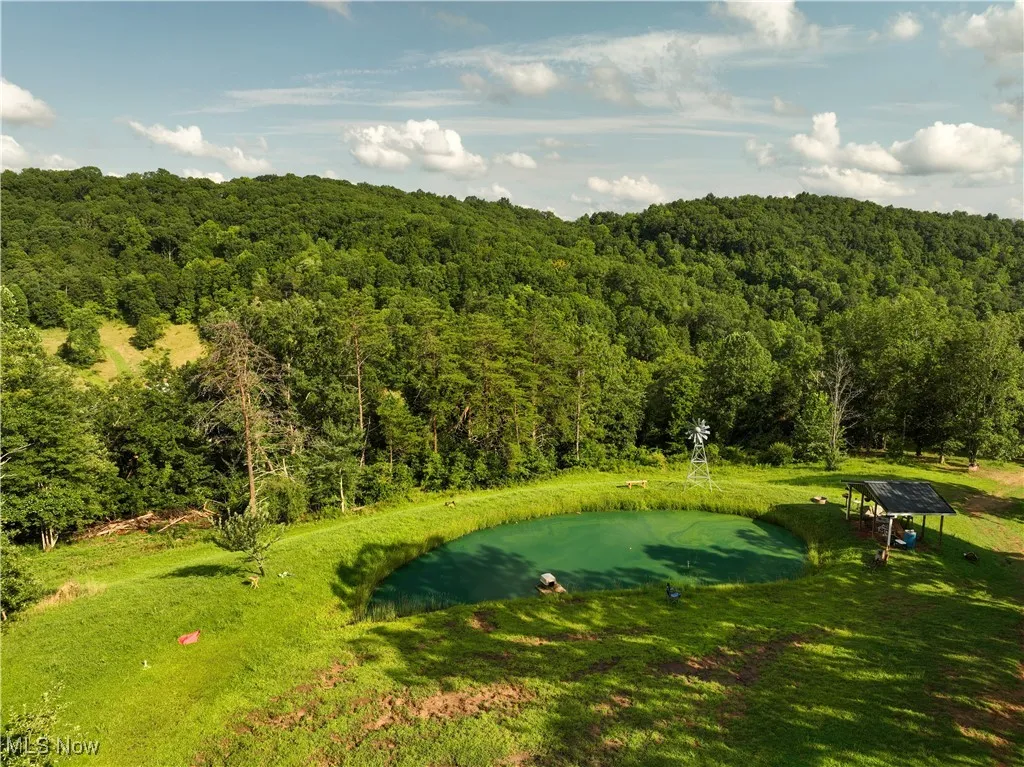 View of community featuring a forest view and view of golf course