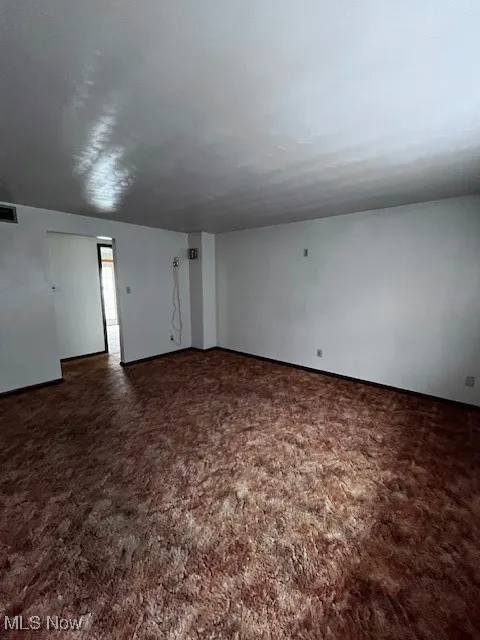 Empty room featuring carpet flooring