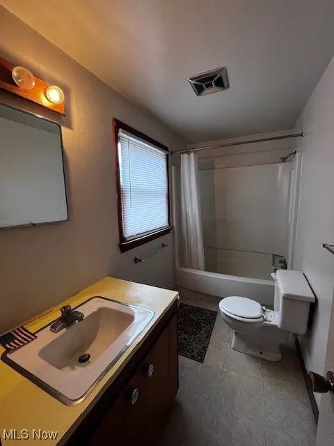 Bathroom featuring vanity and shower / tub combo