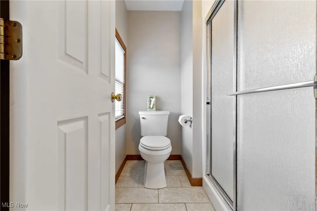 Full bath with a stall shower and tile patterned floors
