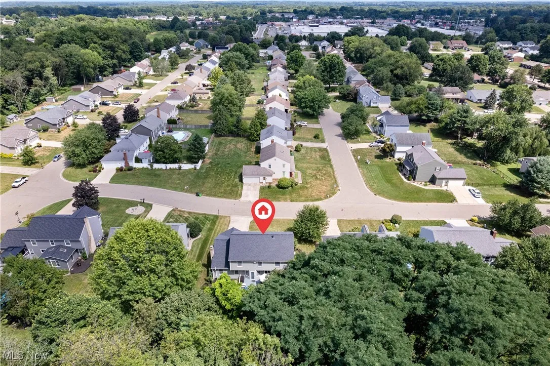 Aerial view of property and surrounding area with nearby suburban area