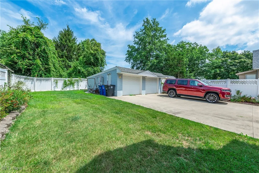 View of yard with an outbuilding and a garage