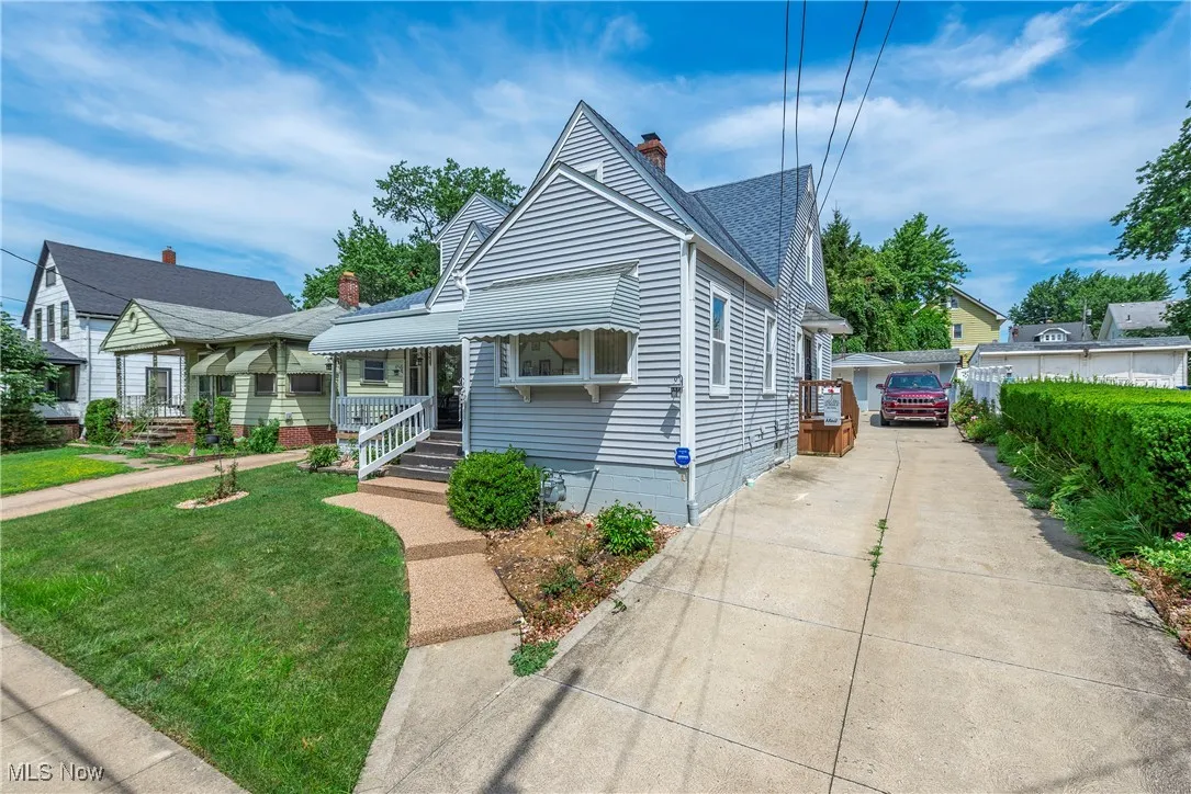 Bungalow-style house with a chimney, a front lawn, a shingled roof, and a porch