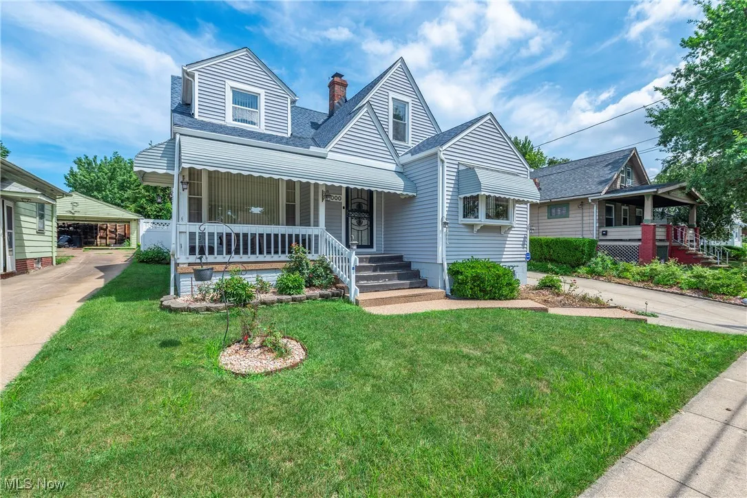 Bungalow featuring covered porch, a front yard, a chimney, and roof with shingles