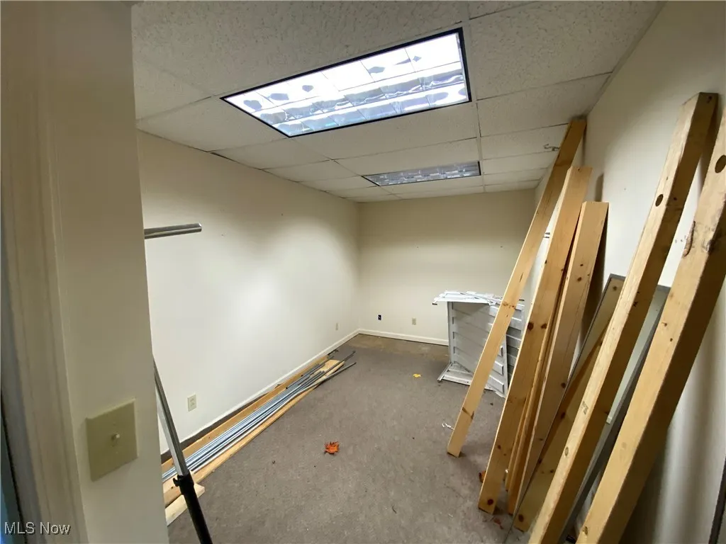 Unfurnished room featuring a drop ceiling