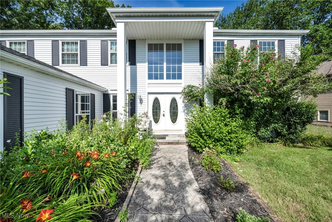 View of front of house with french doors and a front yard