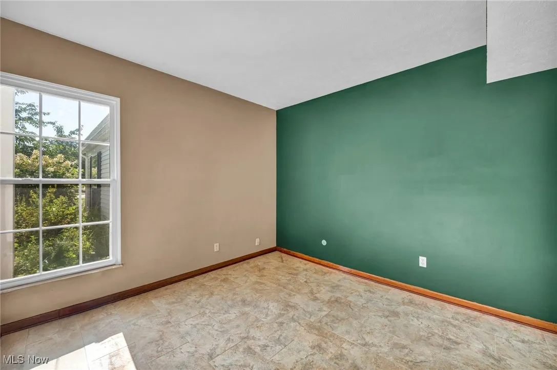 Empty room featuring baseboards